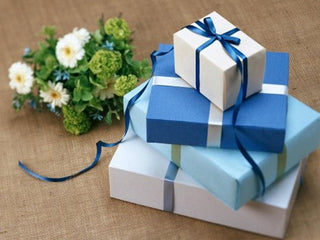 Christian Gifts that Inspire: Gift-wrapped boxes stacked beside a plant