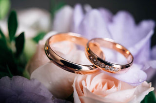 Celebrating Life's Milestones: Image of Wedding Rings and Flowers